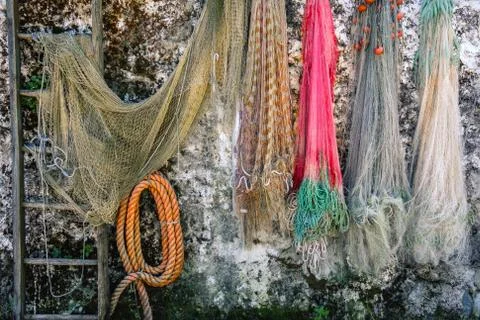 Fishing nets hanging on wall background fishnet Stock Photos