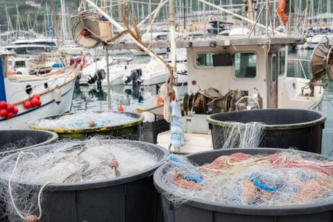 Fishing nets inside huge plastic bins 库存照片