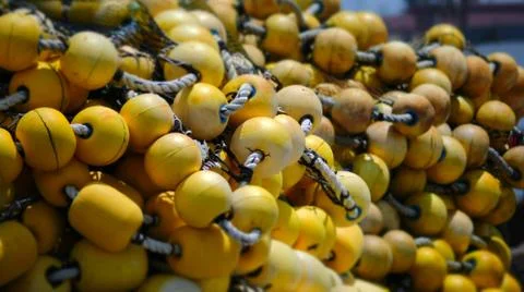 FISHING NETS PILED ON THE DOCK Stock Photos