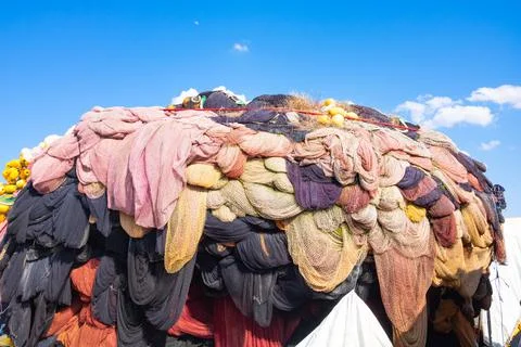 Fishing nets stack or heap in the fishing harbor. Stock Photos