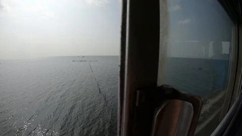 Fishing nets in strait far boats view from window of moving local sri-lankan bus Stock Footage 111369370