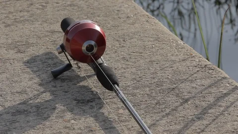 Fishing pole by water Stock Footage