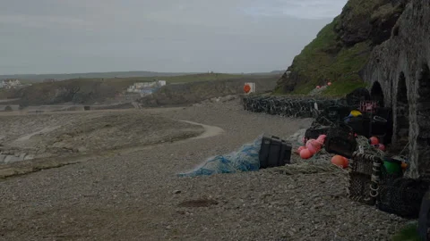 Fishing pots on a pebble beach Stock Footage 233709027