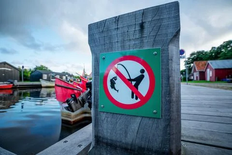 Fishing prohibited sign on a wooden pier Stock Photos