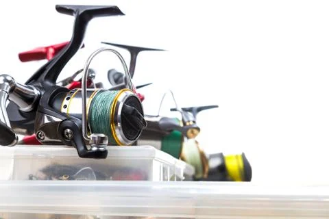 Fishing reels on storage boxes with baits Stock Photos