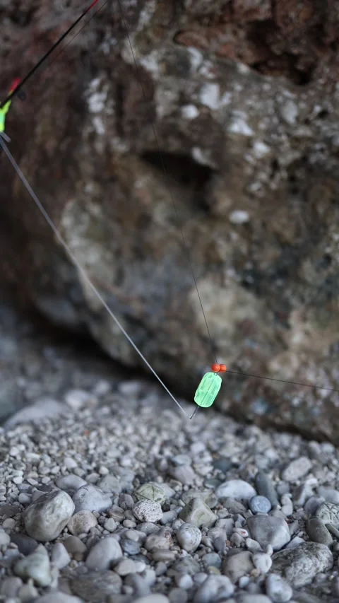 Fishing rig prepared for a quiet evening cast from the rocky shore 動画素材 341321278