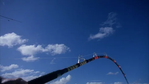 Fishing rod bending while being reeled in Stock Footage 120111638