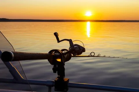 Fishing rod spinning with the line close-up. Fishing rod in rod holder in f.. Stock-Fotos