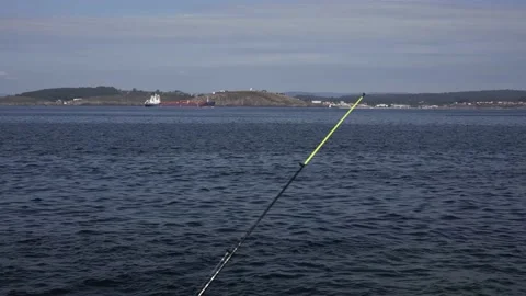 Fishing rod stands against the background of the ocean Stock Footage 206366334