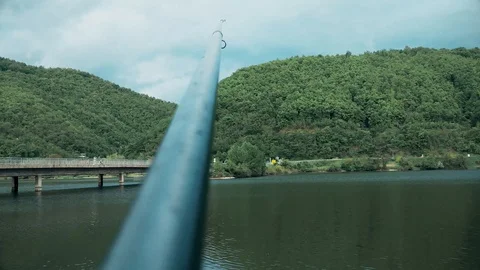 The fishing rod stands on the stand, bridge is in the distance Vídeo Stock 109164609