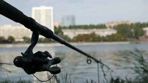 The fishing rod is stretched above the surface of the water, fishing gear Video stock 114979422