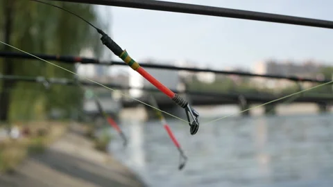 The fishing rod is stretched above the surface of the water, fishing gear Stock Footage 115492550