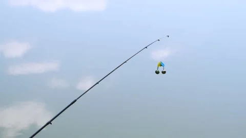 Fishing Rod Tip with Bells Bite Alarm Against Blue Cloudy Sky Video stock 328357076