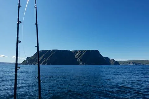 Fishing rods and dramatic North Cape cliffs Stock Photos