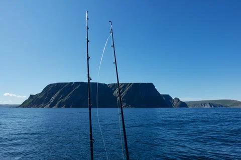 Fishing rods and dramatic North Cape cliffs Stock Photos