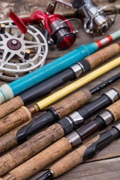 Fishing rods and reels on wooden boards Stock Photos