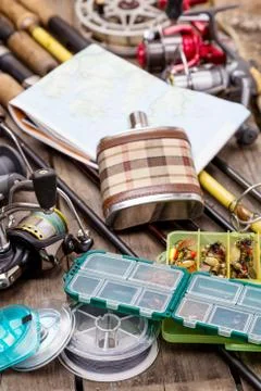Fishing rods and reels on wooden boards Stock Photos