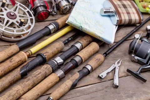 Fishing rods and reels on wooden boards Stock Photos