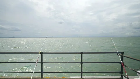 Fishing rods are left by the seashore to catch fish in the sea. Stock Footage 168876913