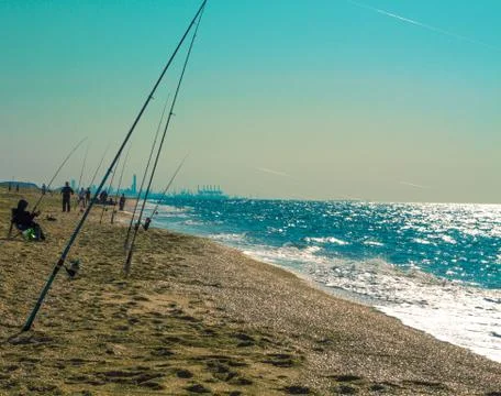 Fishing rods on the beach. Stock Photos