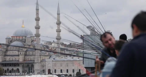 Fishing rods frame New Mosque skyline from Galata Bridge, Istanbul Video stock 321035701