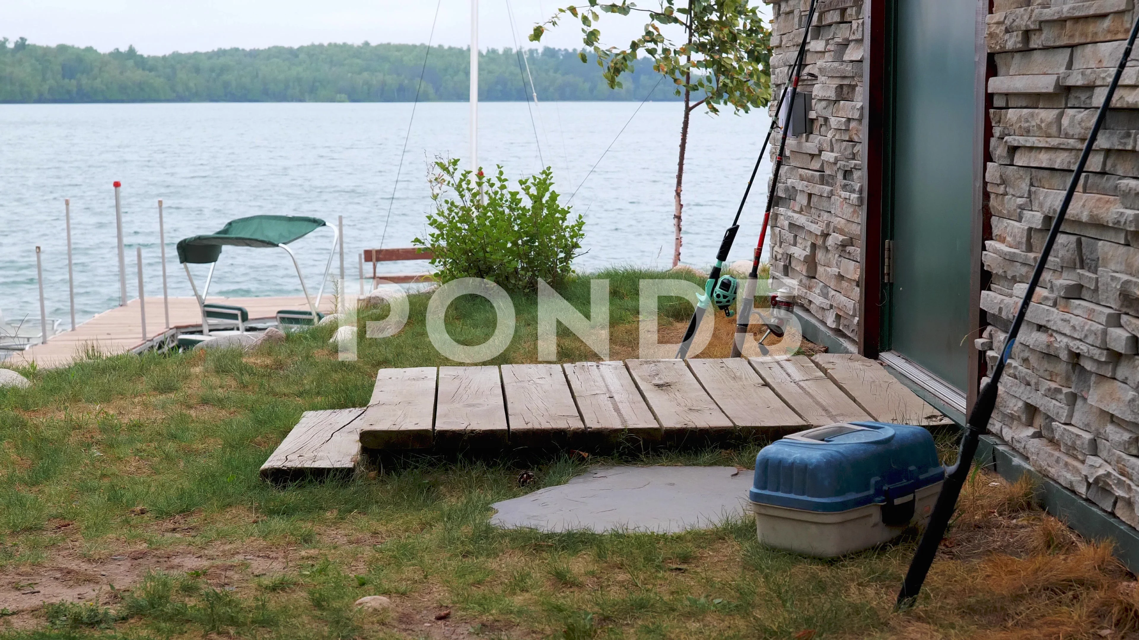 https://images.pond5.com/fishing-rods-lean-against-cabin-160777760_prevstill.jpeg