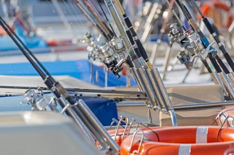 Fishing rods ready to fish on the deck of a fishing pleasure boa Stock Photos
