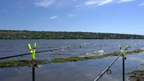 Fishing Rods Set Up on Shore Waiting for a Catch Vídeos de archivo 342330401