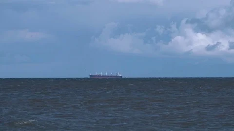 Fishing ship at sea in the distance Stock Footage