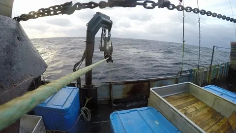 Fishing ship with stretched rope winding up during day time, United States Video stock 138892053