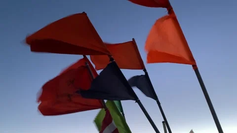 Fishing signal flags flutter in the wind against the ocean at sunset. Stock Footage 302826318