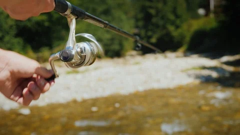 Fishing on a small mountain river, in the frame of a fisherman's hand with a Stock Footage 104108876