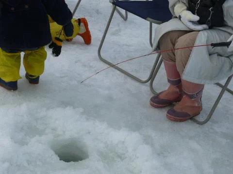 Fishing in snow Stock Photos