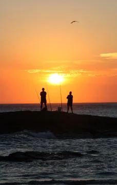 Fishing at sunset Stock Photos