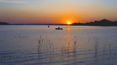 Fishing at sunset Stock Photos