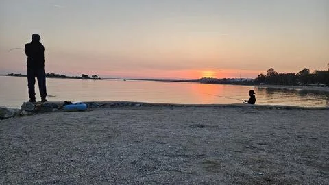 Fishing at sunset Stock Photos