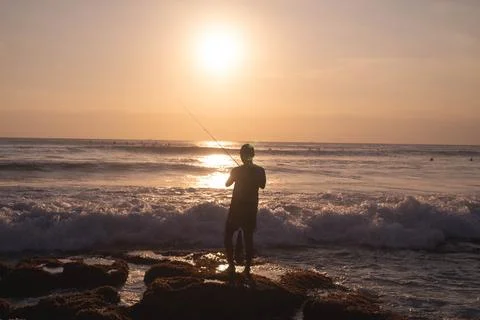 Fishing at sunset Stock Photos