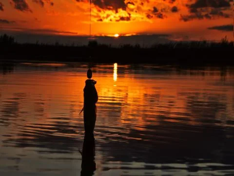 Fishing at sunset Stock Photos