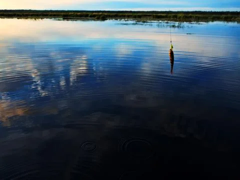 Fishing at sunset Stock Photos