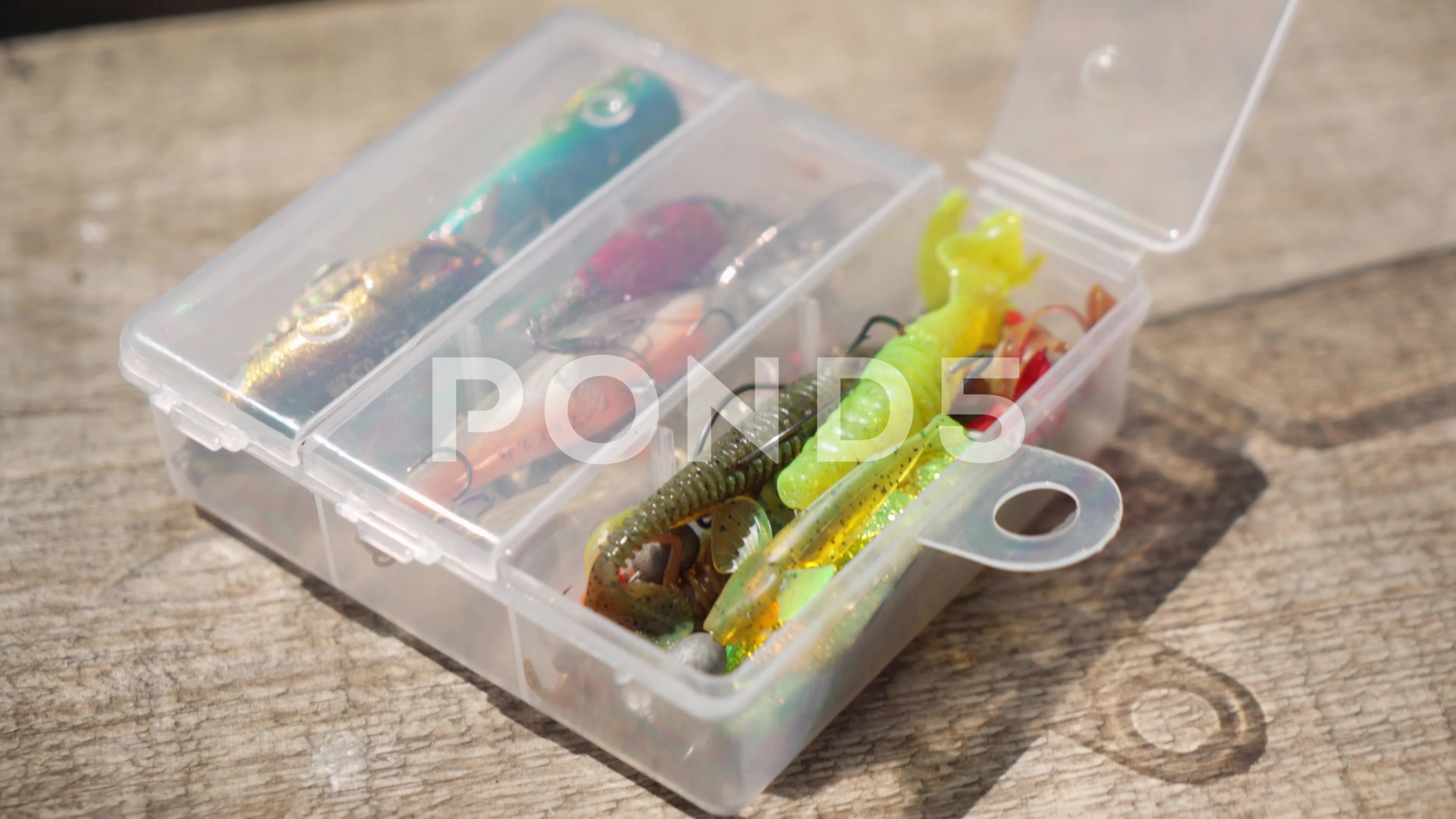 Fishing tackle and lures in a box on a w, Stock Video