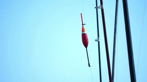 Fishing tackle on the blue background of the sky. Video stock 112735678