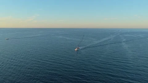 Fishing trawler boat sailing on the open blue sea Stockbeeldmateriaal 330420775