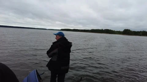 Fishing trip in the lake during cloudy weather with friends and nature nearby Stock Footage 338304076