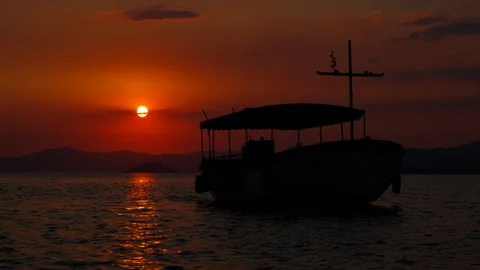 Fishing vessel on calm waves in nightfall. Stock Footage 309507189