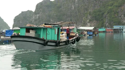 Fishing vessel getting on the ocean from a floating fishing village, Ha Long Bay Video stock 146741494