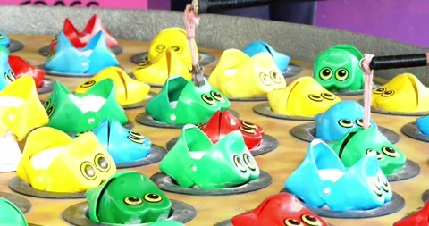 Fishing whack a mole or fried frogs carnival game on the midway of a county fair Stock Footage 246996387