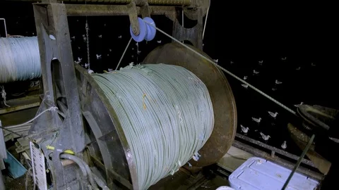 Fishing winch with long rope on ship during night time with artificial light Stock Footage 138892441