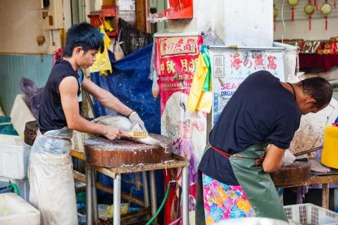 Fishmonger cleans fresh fish 스톡 사진