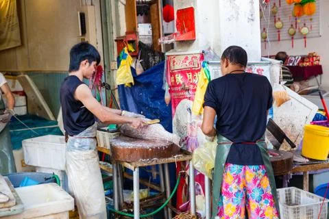 Fishmonger cleans fresh fish Stock Photos