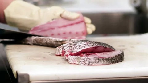 Fishmonger cutting fish Stock Footage 75451626